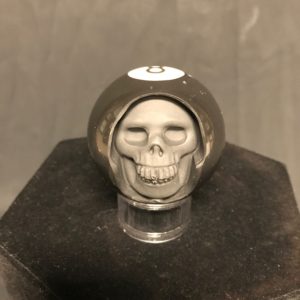 Eight ball carved into human skull