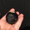 Eight ball carved into human skull